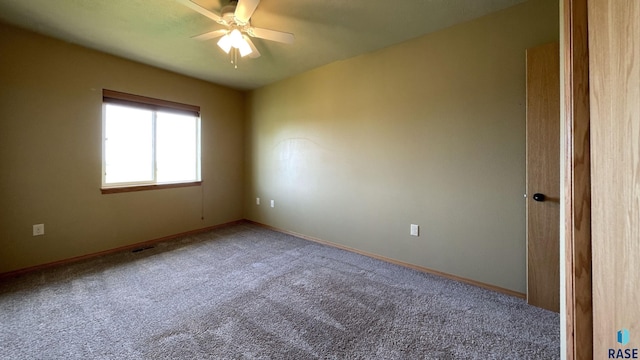 empty room featuring carpet and ceiling fan