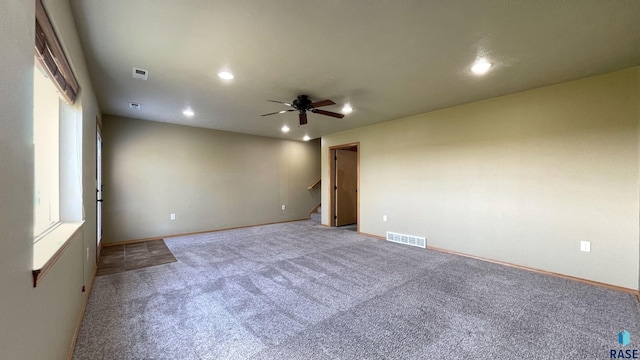 carpeted empty room featuring ceiling fan