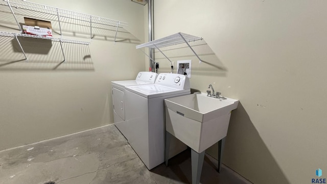 laundry room with separate washer and dryer and sink