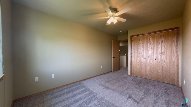 unfurnished bedroom featuring light carpet, a closet, and ceiling fan