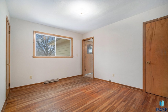 spare room with hardwood / wood-style flooring