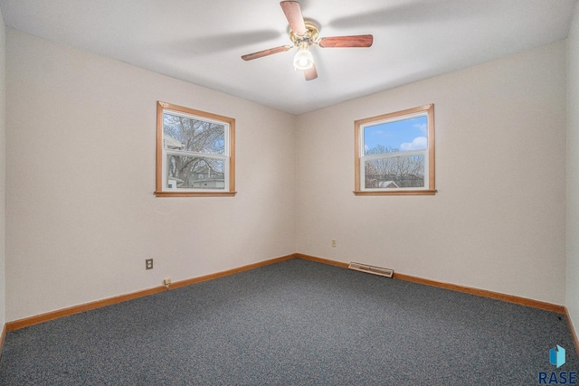 spare room featuring carpet, plenty of natural light, and ceiling fan