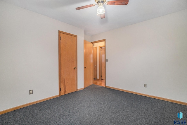 empty room with carpet flooring and ceiling fan