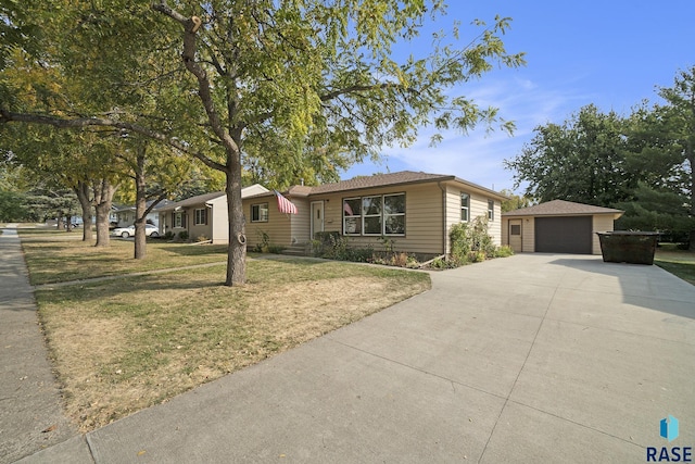 single story home with an outbuilding, a front lawn, and a garage