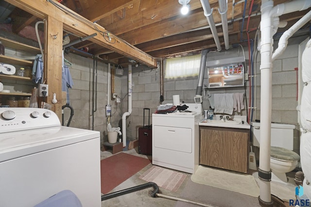 washroom with separate washer and dryer and sink