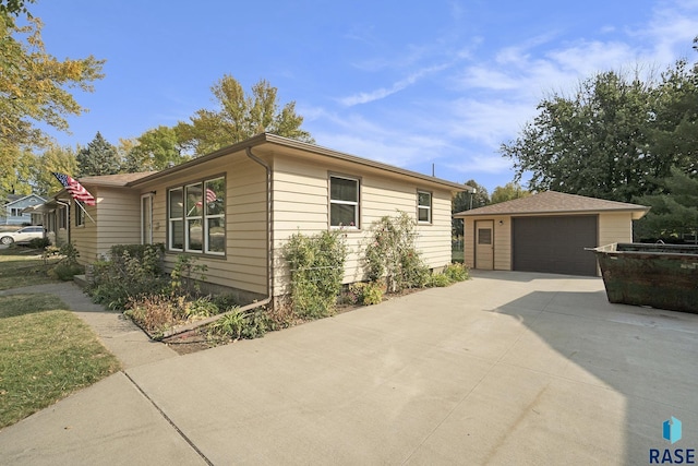 single story home with an outbuilding and a garage