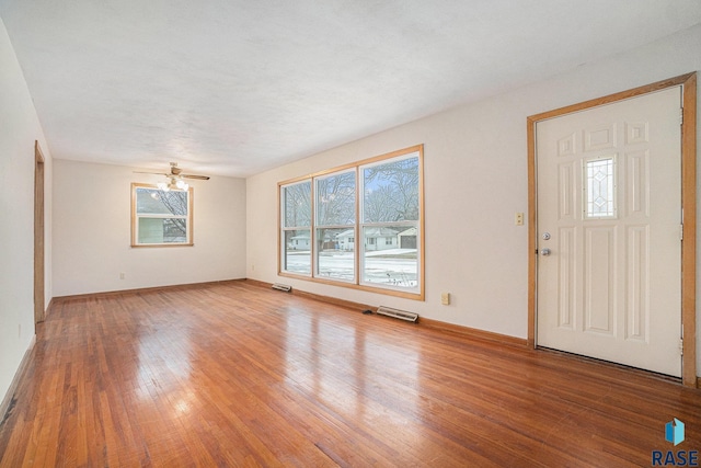 foyer entrance with ceiling fan and wood-type flooring