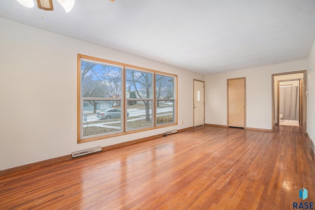 spare room with ceiling fan and hardwood / wood-style flooring