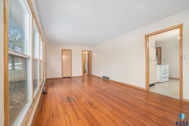 unfurnished room with light hardwood / wood-style floors