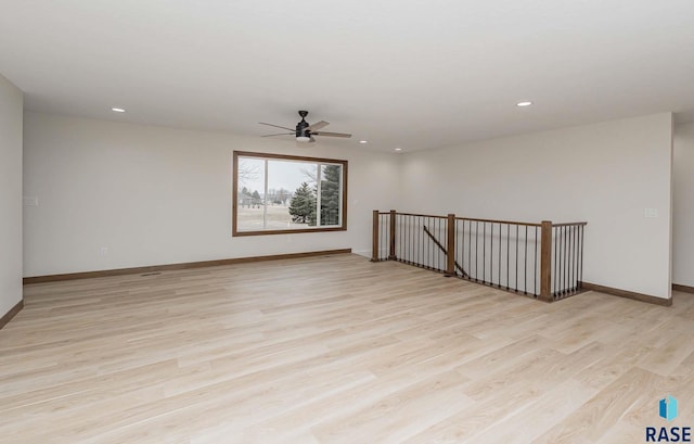 unfurnished room with light wood-type flooring and ceiling fan