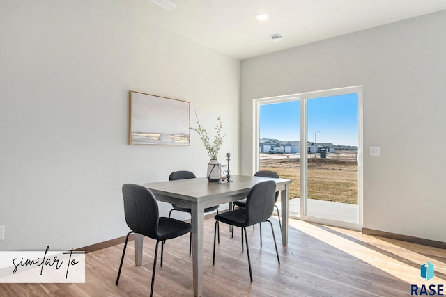 dining area with light hardwood / wood-style floors