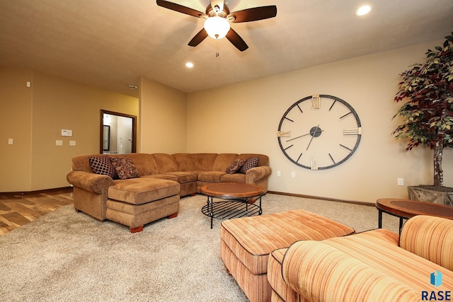 carpeted living room with ceiling fan