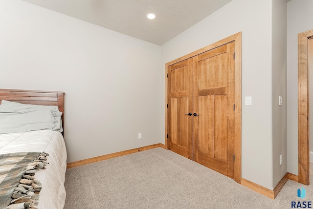 carpeted bedroom featuring a closet