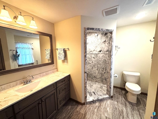 bathroom featuring toilet, vanity, and walk in shower