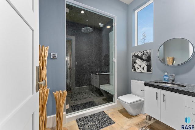 bathroom with tile patterned flooring, vanity, an enclosed shower, and toilet