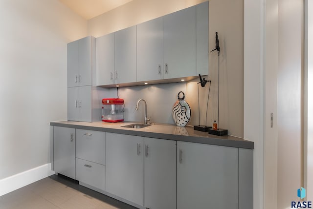 kitchen featuring gray cabinetry and sink