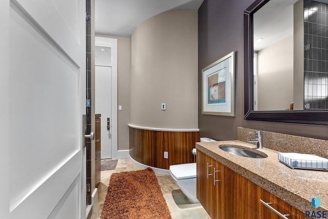 bathroom featuring vanity and toilet