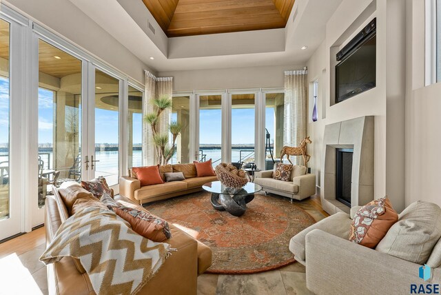 sunroom / solarium with a raised ceiling, french doors, and wood ceiling