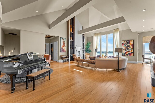 interior space with light hardwood / wood-style flooring and high vaulted ceiling