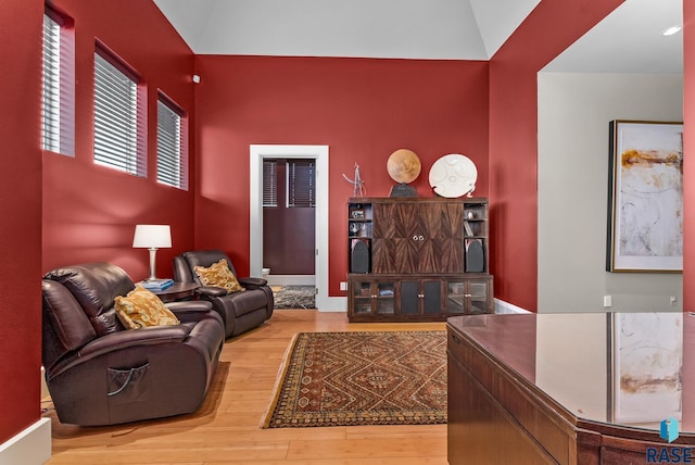 living room featuring hardwood / wood-style floors and lofted ceiling