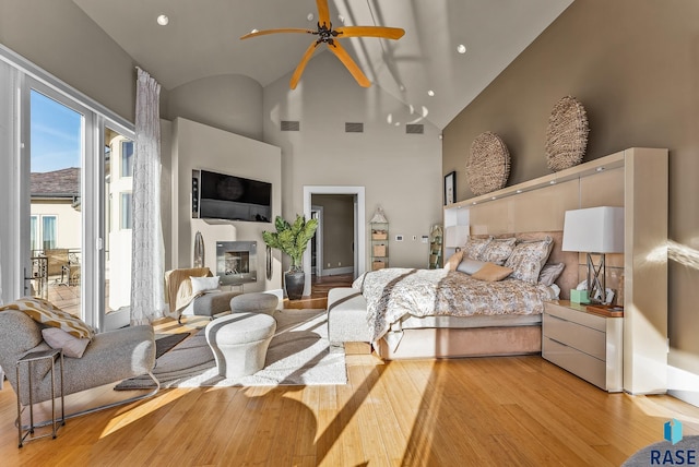 bedroom with light hardwood / wood-style flooring and high vaulted ceiling