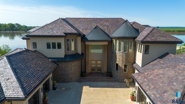 view of front of house with a water view