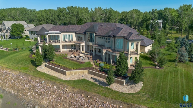 back of property featuring a balcony and a patio