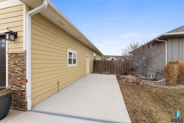 view of property exterior with a patio area