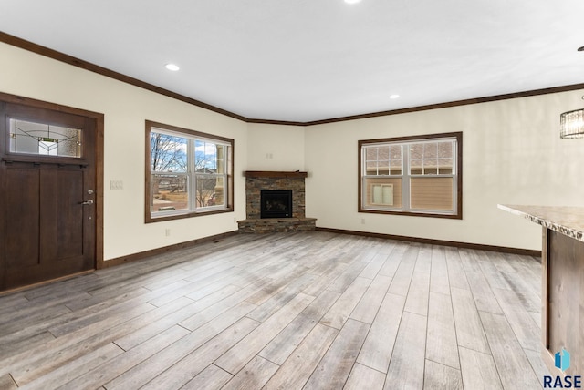 unfurnished living room with a stone fireplace, crown molding, and light wood-type flooring