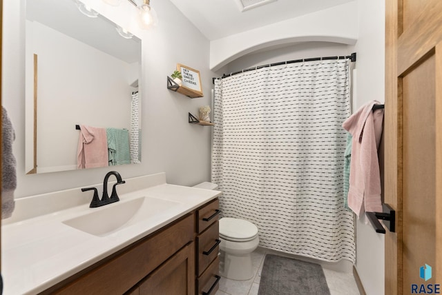 bathroom with tile patterned floors, vanity, curtained shower, and toilet