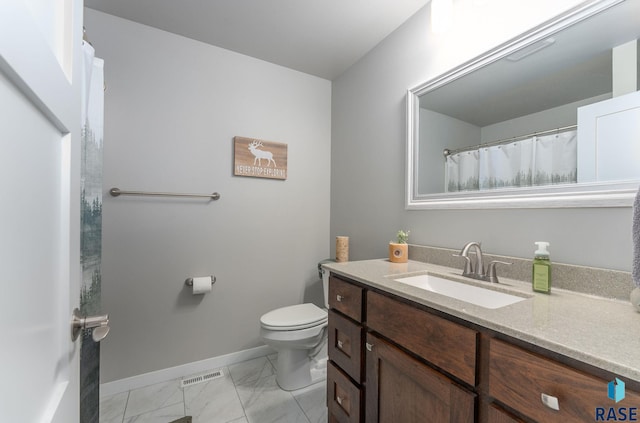 bathroom featuring vanity and toilet