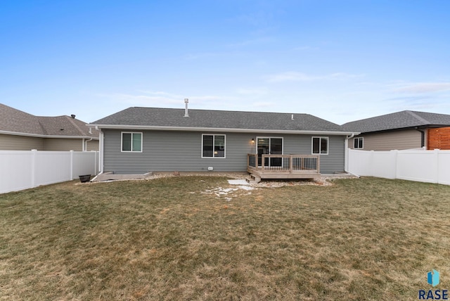 rear view of property with a deck and a lawn