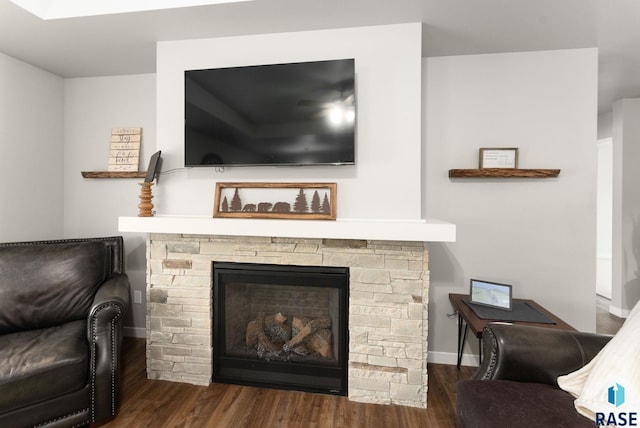 living room with dark hardwood / wood-style floors and a fireplace