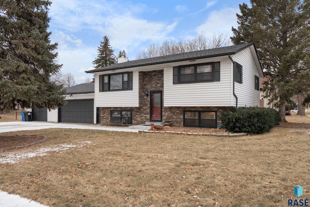 raised ranch with a front yard and a garage