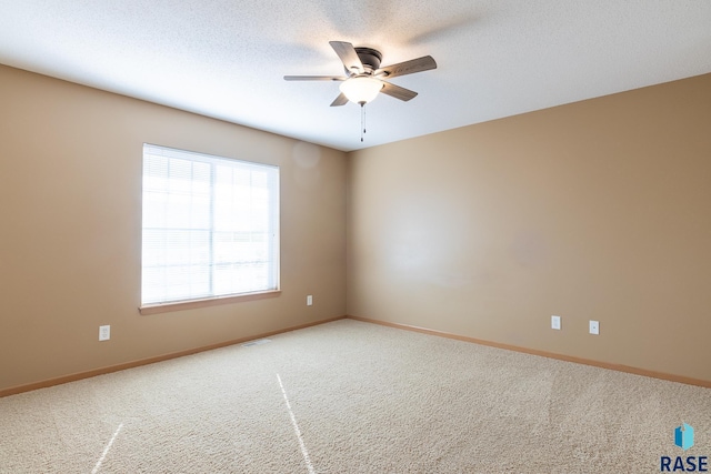 empty room featuring carpet flooring and ceiling fan