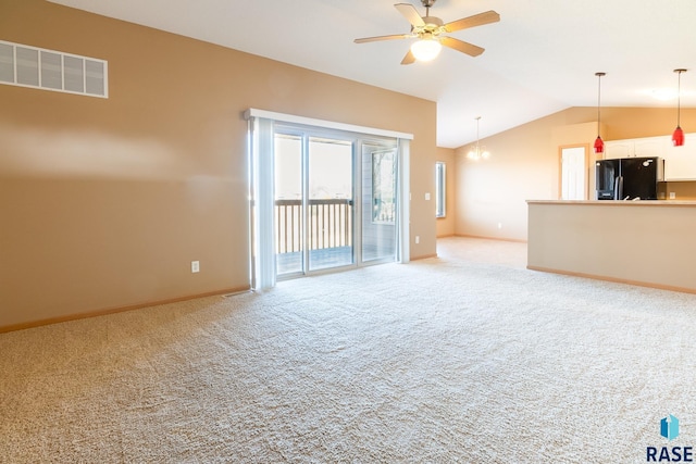 unfurnished living room with ceiling fan, light carpet, and vaulted ceiling