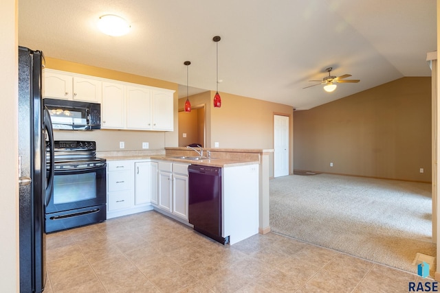 kitchen with sink, kitchen peninsula, pendant lighting, white cabinets, and black appliances