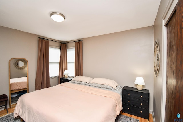 bedroom with a closet and hardwood / wood-style flooring