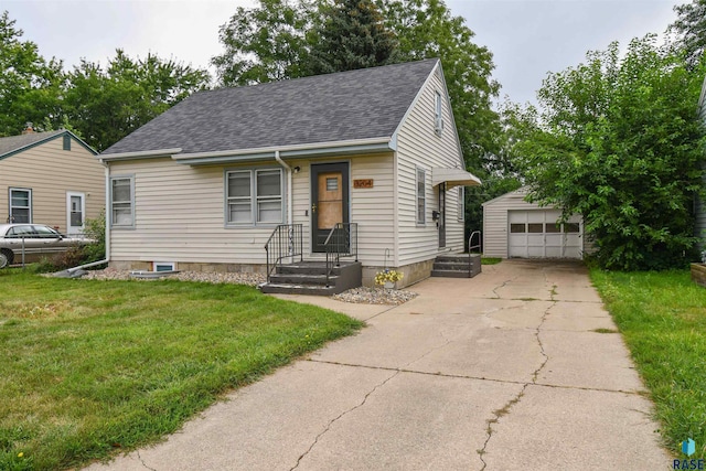 view of front facade with a garage, an outdoor structure, and a front lawn