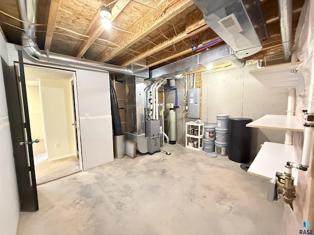 basement featuring electric panel and heating unit