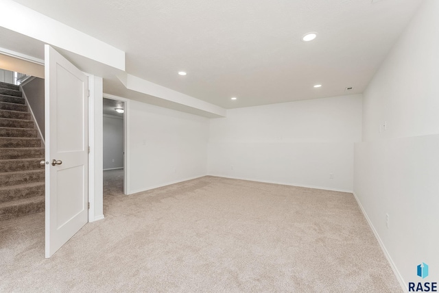 basement featuring light carpet