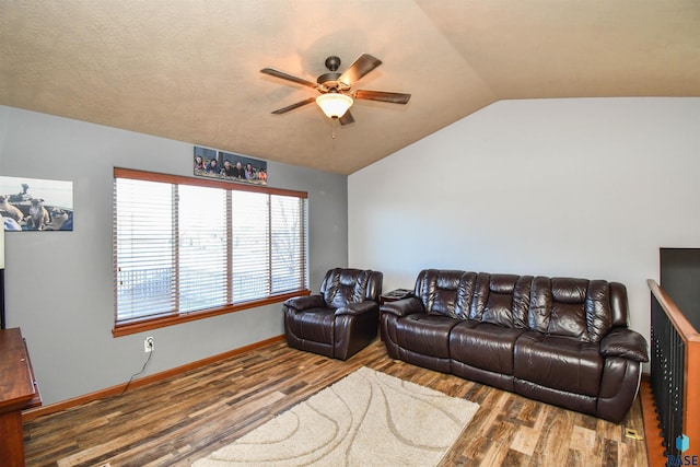 living room featuring hardwood / wood-style flooring, ceiling fan, and lofted ceiling