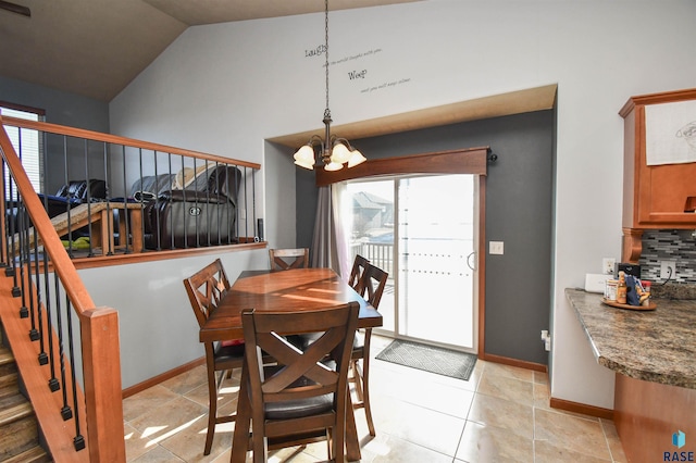 dining room with lofted ceiling, light tile patterned floors, and a chandelier