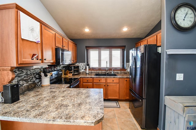 kitchen with black appliances, sink, vaulted ceiling, decorative backsplash, and kitchen peninsula