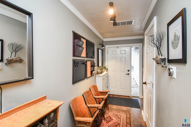 entrance foyer with hardwood / wood-style floors and ornamental molding