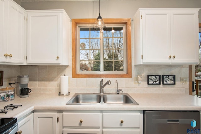 kitchen featuring sink, hanging light fixtures, decorative backsplash, white cabinets, and appliances with stainless steel finishes