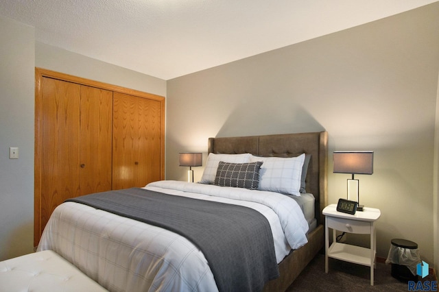 bedroom with a closet and dark carpet