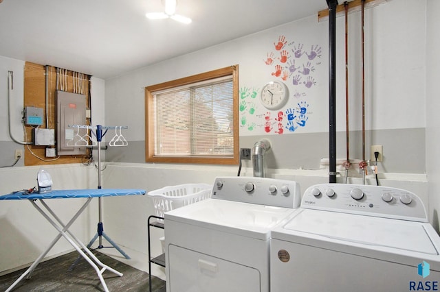 washroom featuring separate washer and dryer, dark wood-type flooring, and electric panel