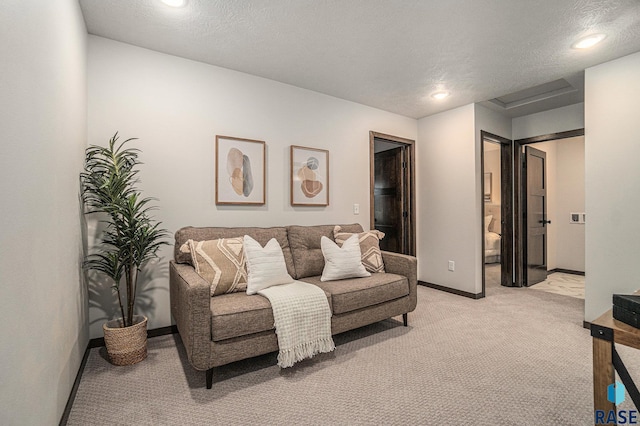 carpeted living room featuring a textured ceiling