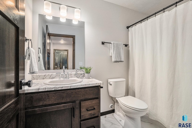 bathroom featuring vanity, toilet, and a textured ceiling